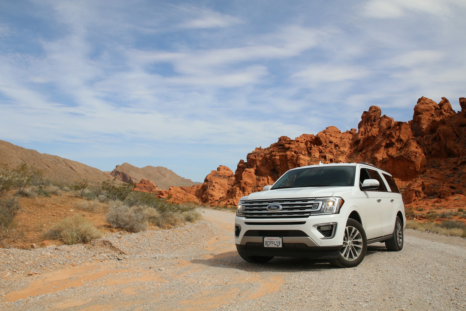 parked white Ford Explorer SUV with auto insurance